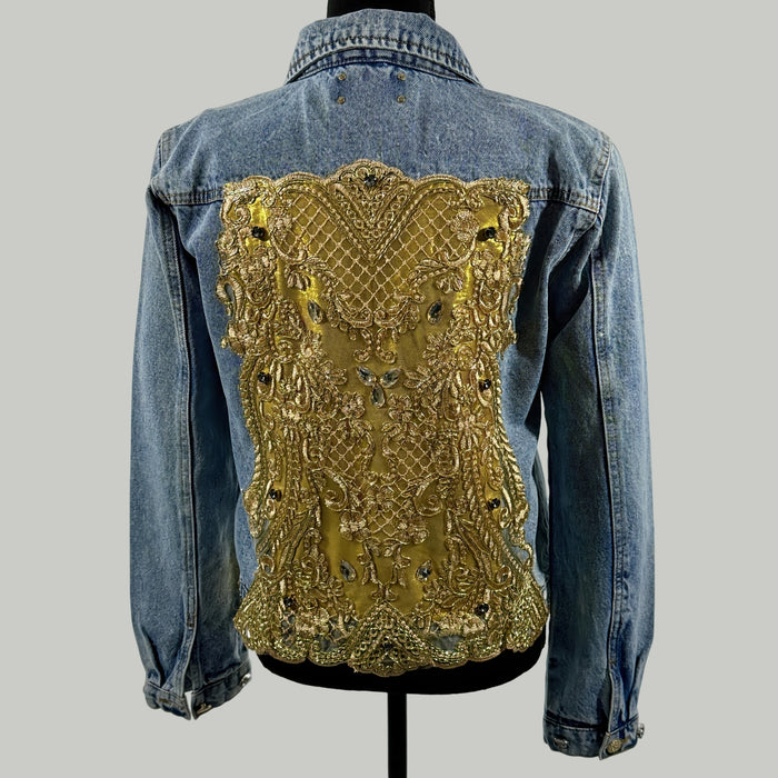 back view of denim jacket with ornate gold embroidered panel