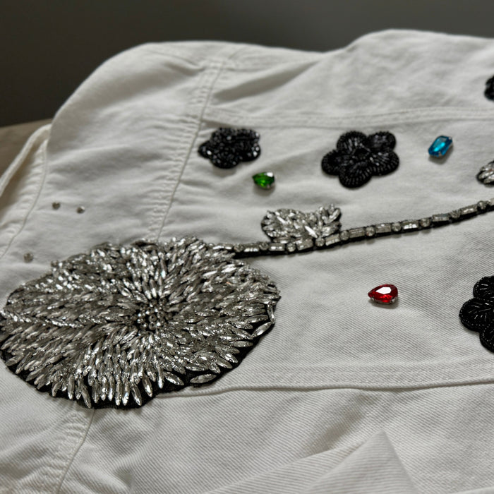 White denim jacket with decorative patches with crystals and gemstones 