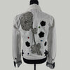 back view of crystal embellished denim jacket with appliqué and fringe