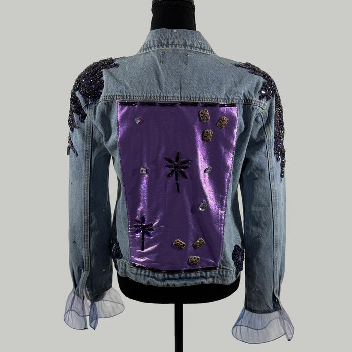 back view of denim jacket with metallic purple satin panel and crystals