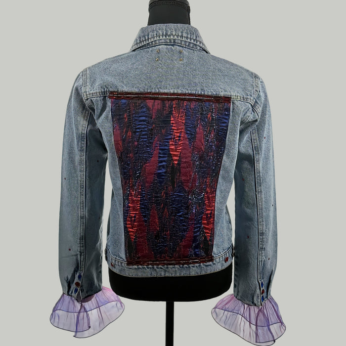 back view of handmade embellished denim jacket with embroidered satin patch