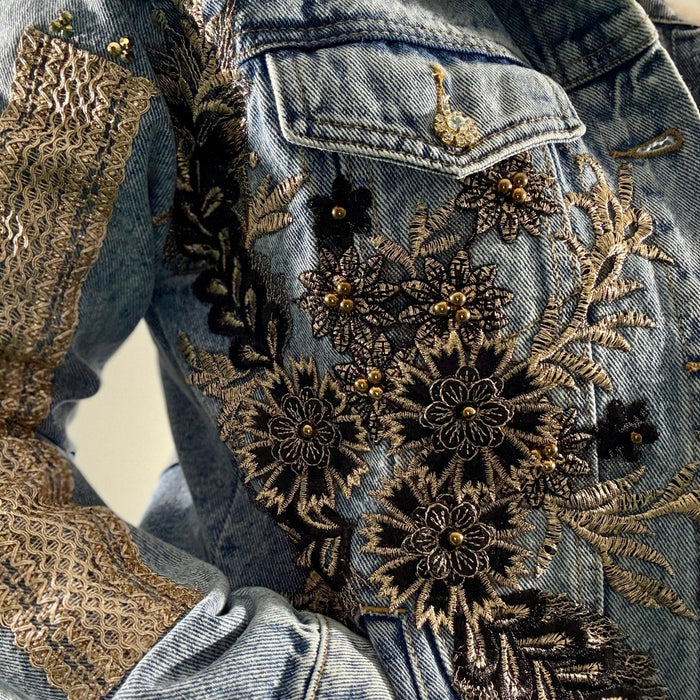 close-up of black and gold floral embroidered denim jacket with beads