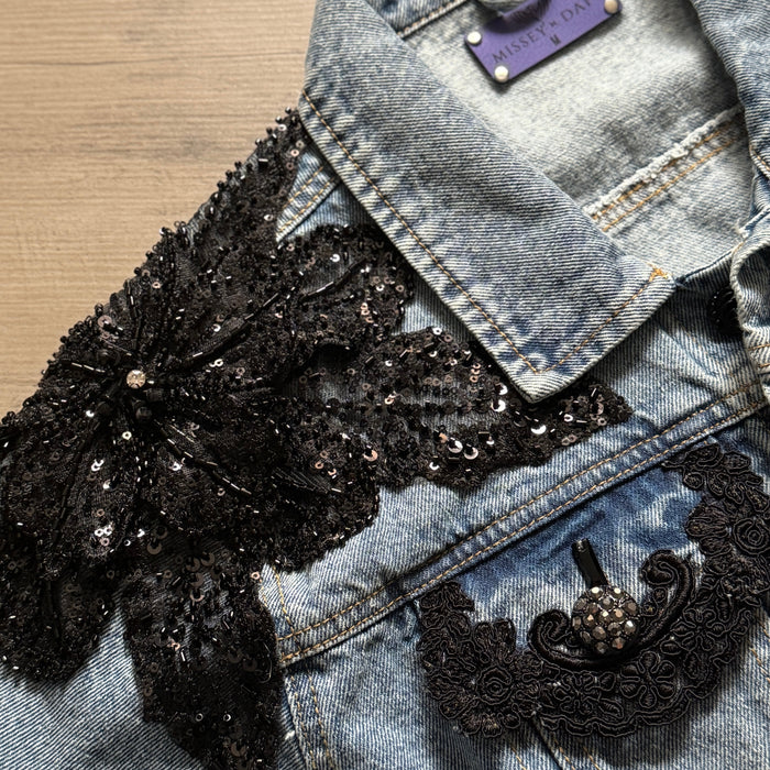 close-up of black lace floral appliqué and beadwork on denim jacket2