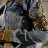 close-up of gold collar and floral appliqué embroidery on denim jacket