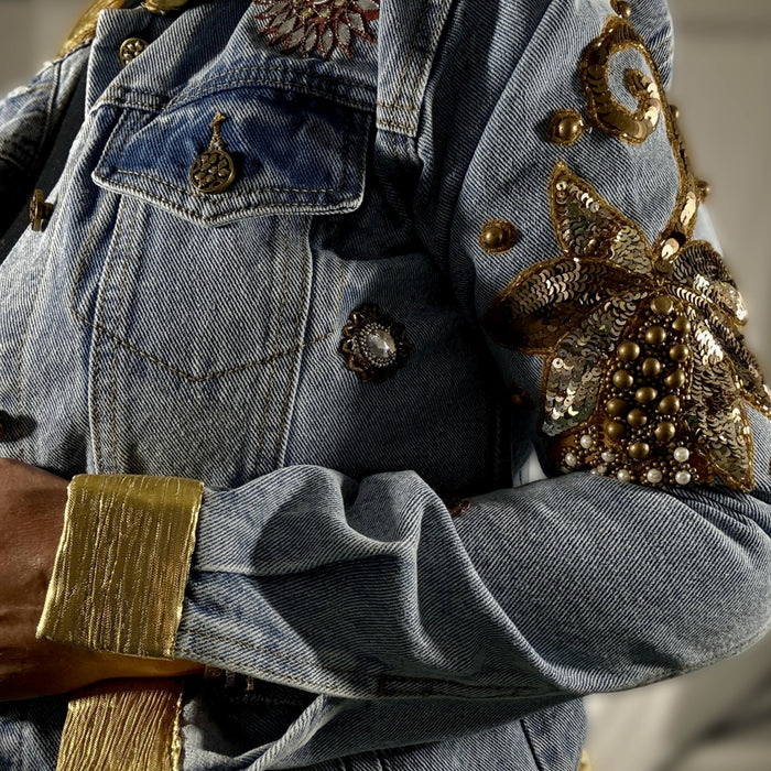 close-up of gold collar and floral appliqué embroidery on denim jacket