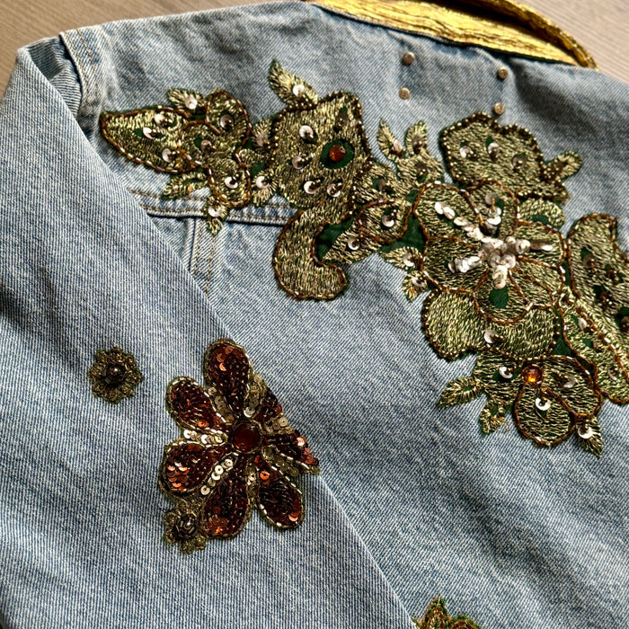 close-up of gold floral appliqué embroidery on the back of the denim jacket