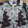 close-up of handcrafted purple floral appliqué beaded embellishments on denim