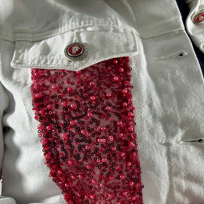 close-up of handmade red bead embroidery on denim jacket