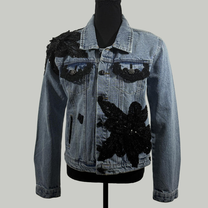 front view of denim jacket with black lace appliqué and sequin embellishments